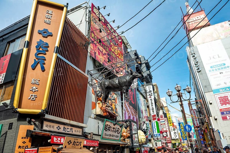 Lots of colorful signs in a pedestrian zone with shops and restaurants, Dotonbori, Osaka, Japan