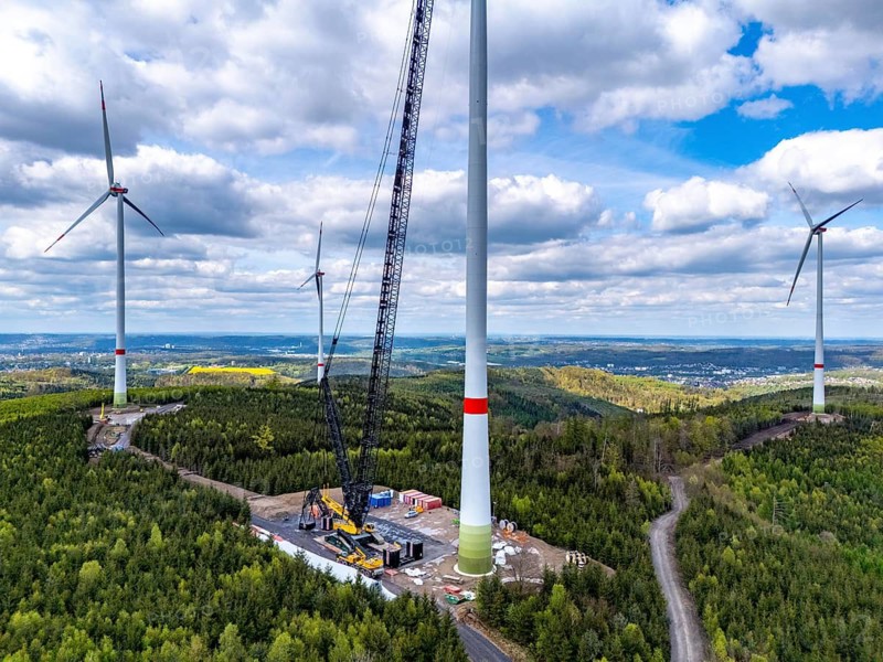 Erection of a wind turbine, wind energy plant, assembly of the ring generator, with a crawler lattice crane, wind farm near Hagen, North Rhine-Westphalia, Germany