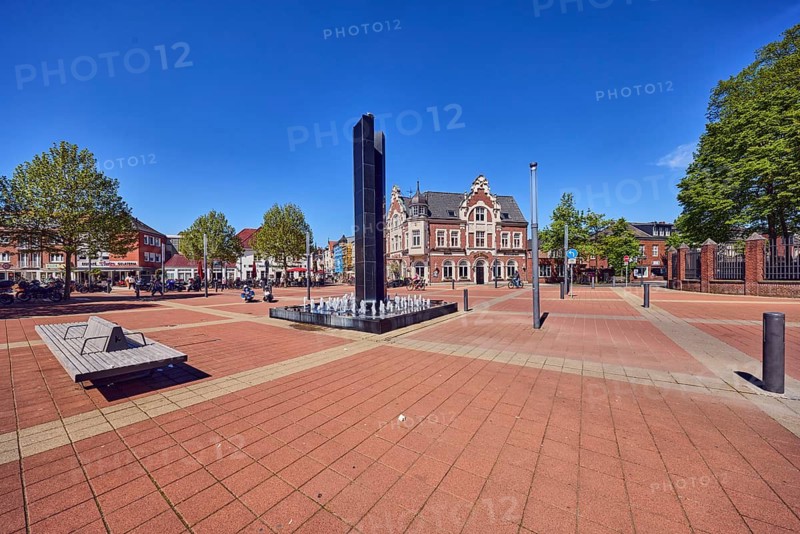 City center, Black Fountain water feature, benches, public seating area, residential and commercial building, historic building, square, barrier bollard, pedestrian area, trees, blue sky, cloudless, confluence Geldener Straße, Bahnstraße, main street and Marktstraße in Roermonder Platz, Kevelaer, Kleve district, North Rhine-Westphalia, Germany