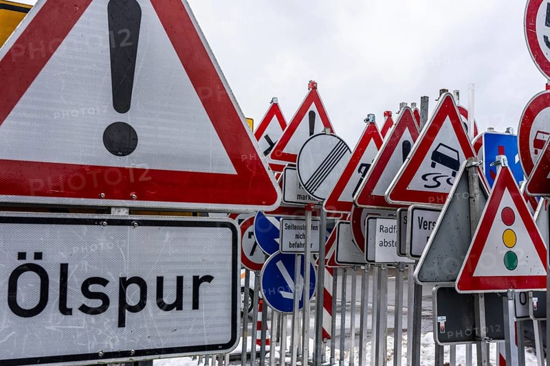Storage for traffic signs in the yard of a road maintenance department, various signs with commandments and prohibitions, information about dangers, road traffic