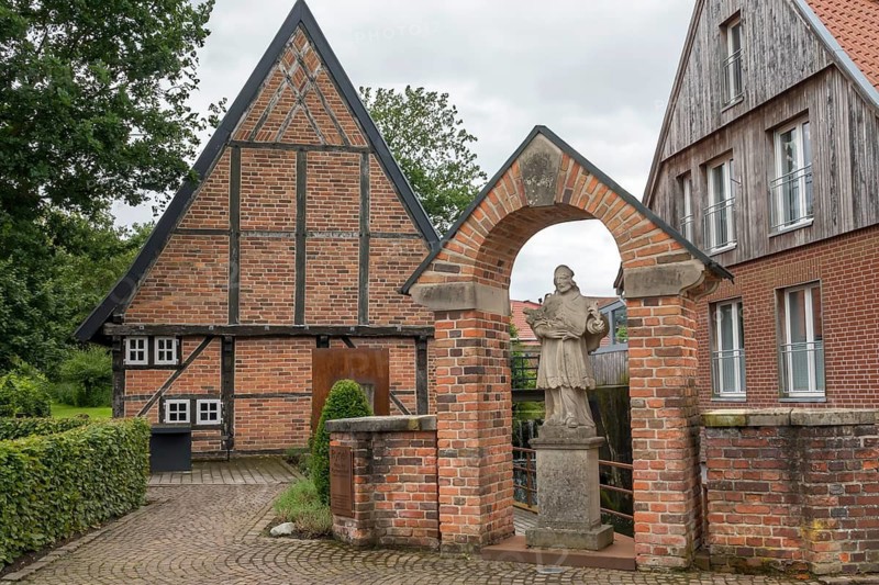 Nepomuk statue at the historic watermill, Stiftsmühle from 1653, Asbeck, Legden, Münsterland, North Rhine-Westphalia, Germany