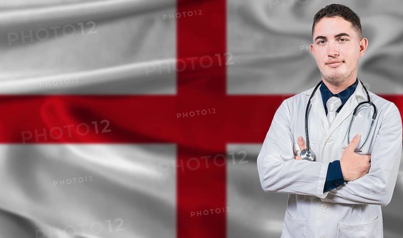 Portrait of medical professional on England flag background. English national health system