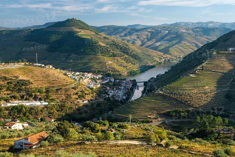 Regua town in Douro Valley Portugal, with winding Douro river, vineyard hills, mountain layers and terraced rows