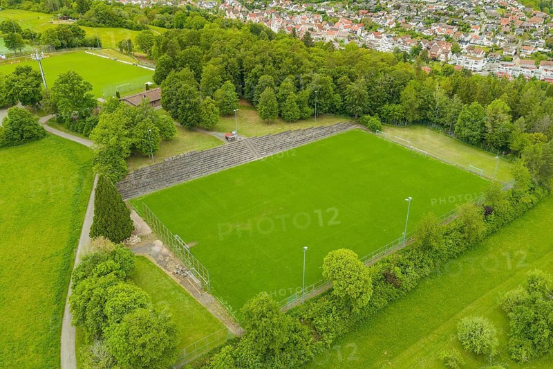 Football field with stand, surrounded by a rural landscape and lots of greenery, Aidlingen sports field, Böblingen district, Germany