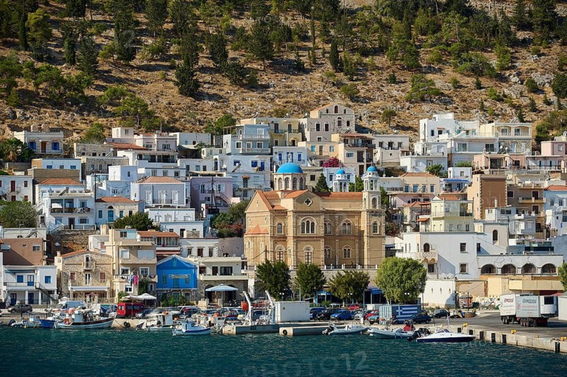 Port town with lively shore, buildings and a distinctive waterfront church, Pothia, main town, port, Kalymnos, Sponge Diving Island, Dodecanese, Greek Islands, Greece