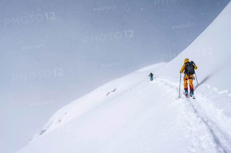 Ski tourers in a snowy mountain landscape, ascent to the Wildhorn, cloudy mood, high tour, Bernese Alps, Bernese Oberland, Switzerland