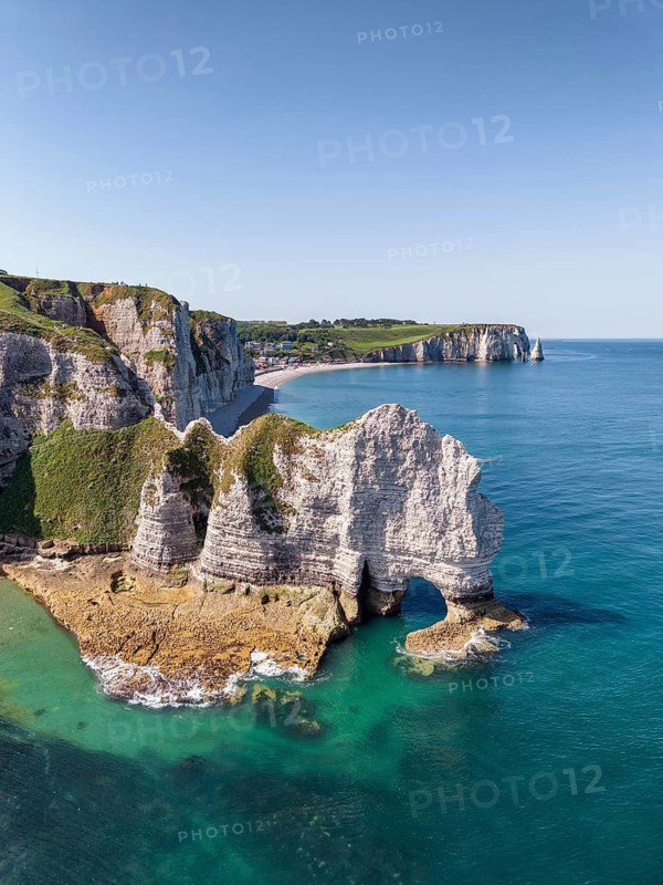 Aerial view of the Falaise d'Amont rock formation with the Porte d'Amont rock gate at low tide, on the horizon the Porte d'Aval rock formation, Étretat, Alabaster Coast, La Côte d'Albâtre, chalk cliffs, English Channel, Seine-Maritime, Normandy, France
