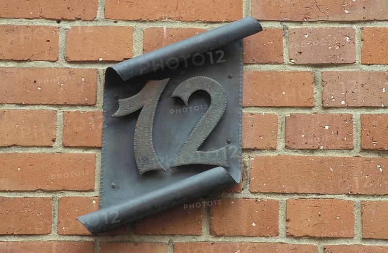 Black house sign 12 on rolled metal sheet, number, number, rolled, handmade, ironwork, red bricks, Eltville, Rheingau, Taunus, Hesse, Germany