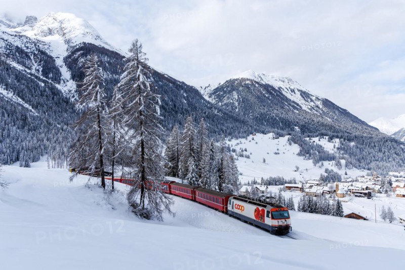 Rhaetian Railway train on the Albula railway Passenger train in the Alps in Bergün, Switzerland