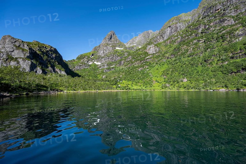 Mountains reflected in the water of the fjord Trollfjord, fjord landscape and mountains, Lofoten, Nordland, Norway