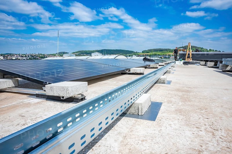 Solar panels on a roof with a view of landscape and blue sky, industrial environment, PV installation, Perrot company, Calw, Germany