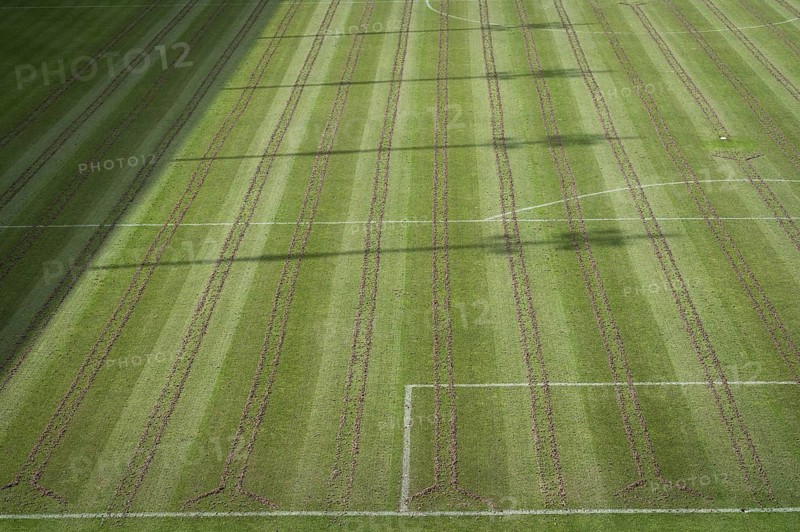 Soccer pitch with pices of soil after aeration maintance