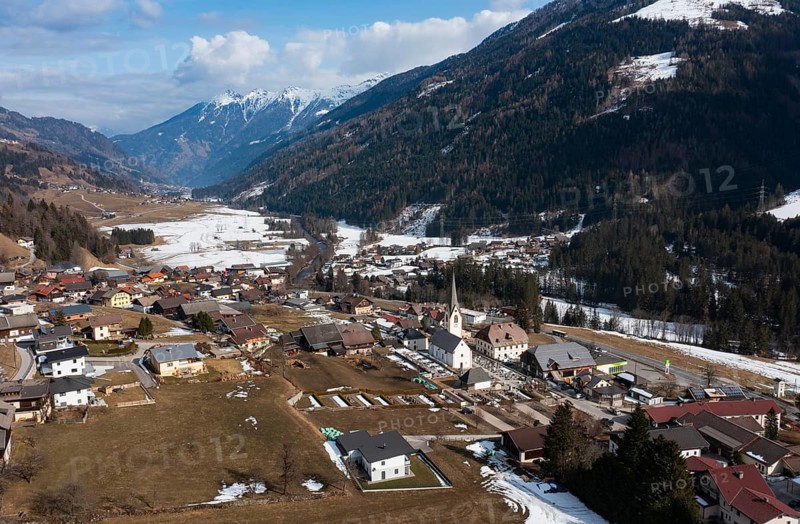 Drone shot, view of village with parish church, Rangersdorf, Mölltal, Carinthia, Austria