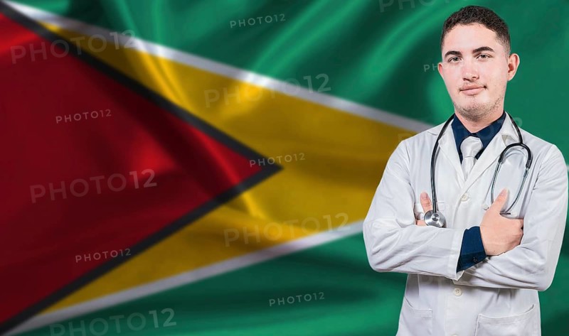 Portrait of medical professional on Guyana flag background.Guyanese national health system