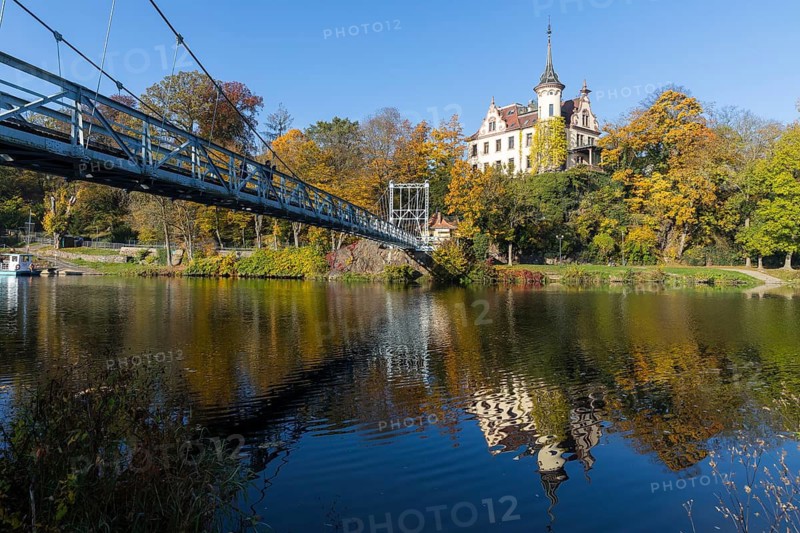 Gattersburg and suspension bridge over the Mulde in autumn, Grimma, Saxony, Germany