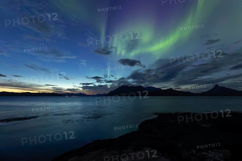 Northern lights at dawn over Sørfolda Fjord near Kjerringøy between Bodø and Sørfold in Norway