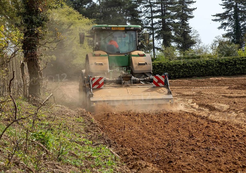 John Deere 8R 340 tractor engaged in field work operating an Agri-World FTC series soil tiller, Shottisham, Suffolk, England, UK