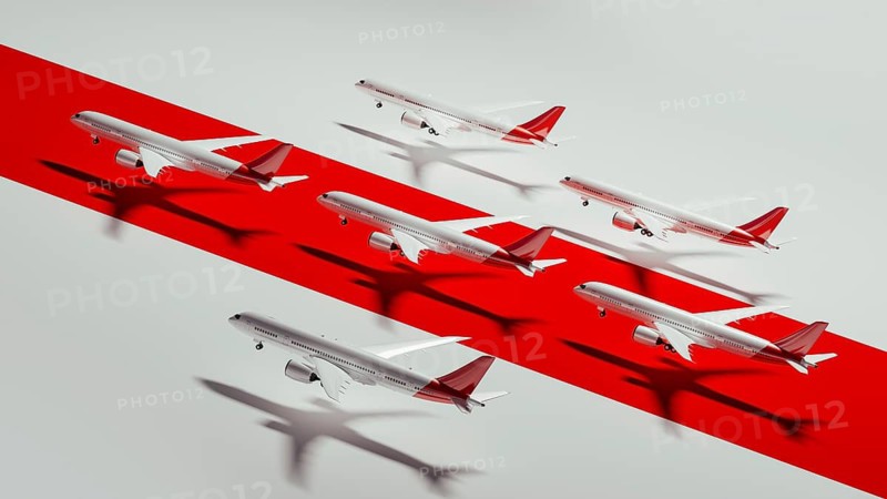 Commercial airplane models are artistically arranged on a bold red stripe, highlighting various angles in a dynamic layout
