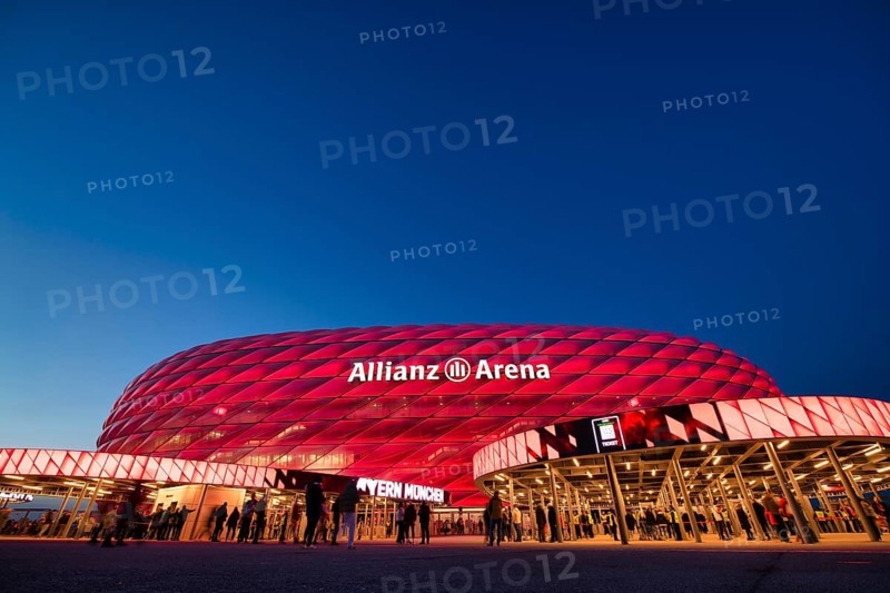 Visitors, fans, entrance area of the Allianz Arena, illuminated, overview, blue hour, in front of a Bundesliga game, Allianz Arena, Munich, Bayern, Germany