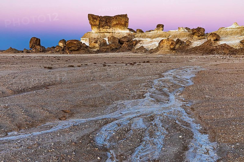 Striking rock formation in the Huqf stone desert in the morning light, at blue hour, Arabian Peninsula, Sultanate of Oman