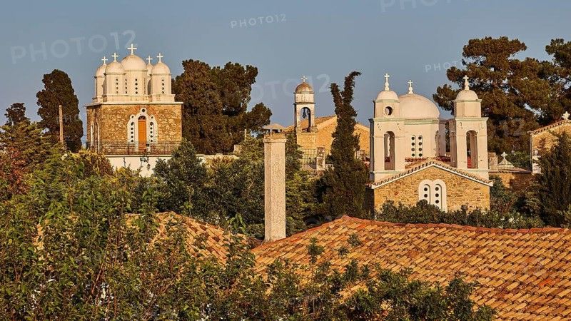 Church architecture with domes and towers against a background of trees in the evening light, Koroni, Byzantine fortress, nunnery, Peloponnese, Greece