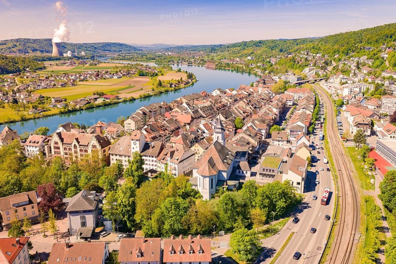 City view with river, church and adjacent houses, surrounded by green hills in summer, electrification of the Hochrheinbahn, conversion of the train station, Waldshut, Tiengen, Germany