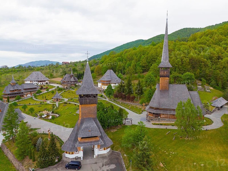 Monastery with wooden churches and steep roofs surrounded by lush green forest, aerial view, Bârsana monastery, Barsana, Maramure?, Maramures, Maramuresh region, Romania