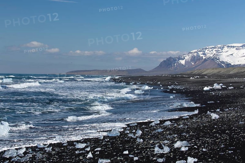 Little icebergs and crushed ice on the black beach at Joekulsarlon glacial lake