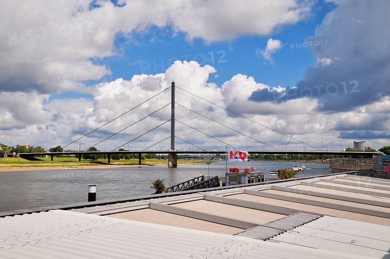 Düsseldorf, Germany - June 9th 2026: View on 'Oberkasseler Brücke' bridge from Riverside promenade 'Rheinuferpromenade' in summer