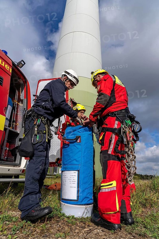 Height rescuers from the Gelsenkirchen fire brigade practise abseiling from a wind turbine from a height of 110 metres after rescuing an accident victim from the nacelle, Gladbeck, North Rhine-Westphalia, Germany