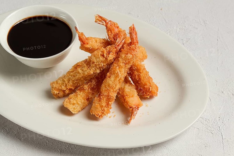 Fried shrimp, peeled in tempura, soy sauce, close-up