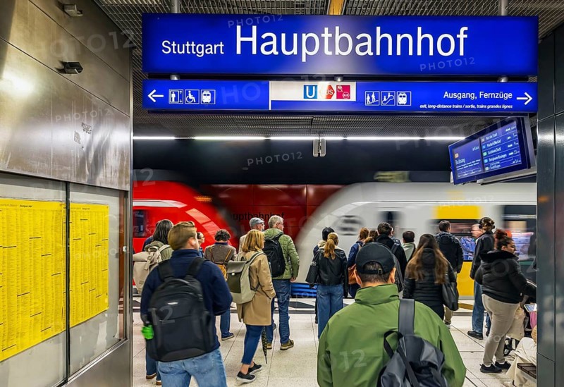 Subway platforms deep in the main train station with waiting passengers. Stuttgart, Baden-Württemberg, Germany