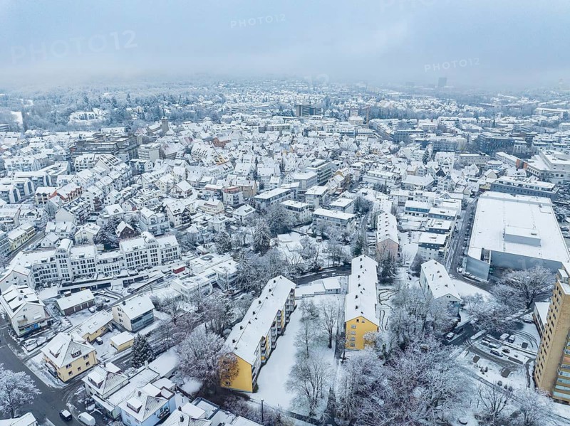 Snow-covered city from above with dense residential buildings and streets, Sindelfingen, Germany