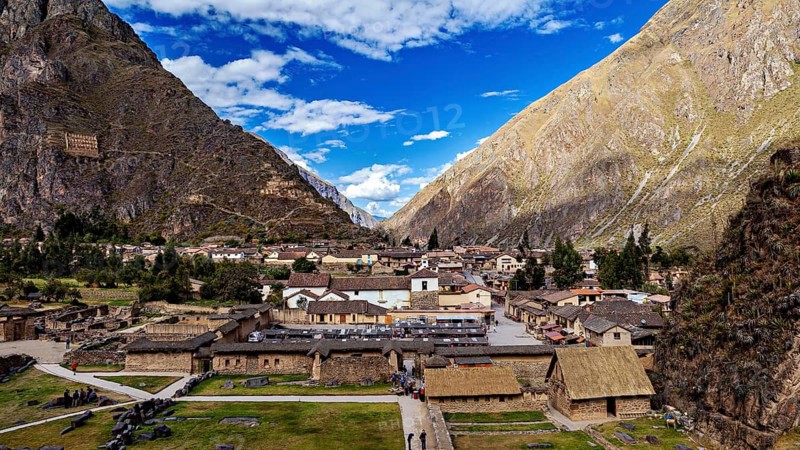 Traditional settlement in the valley between big mountains and blue skies, The Inca ruins of Ollantaytambo in the Andes of Peru