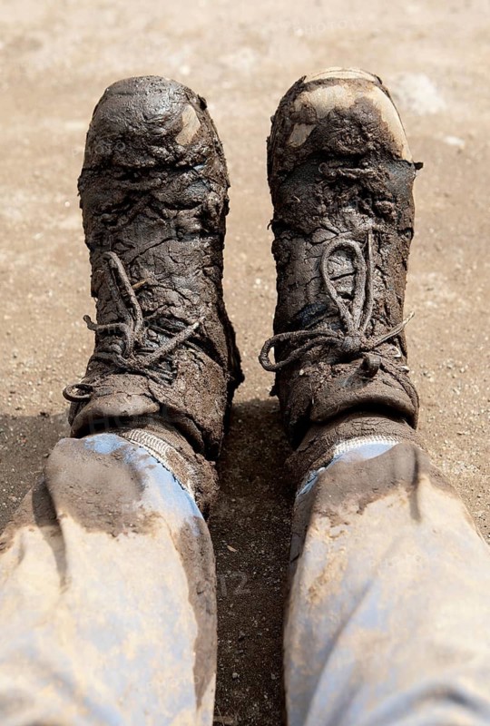 Hiking boots smeared with mud after gorilla tracking, Virunga Volcano Mountains, Parc National des Volcans, Volcanoes National Park, Rwanda