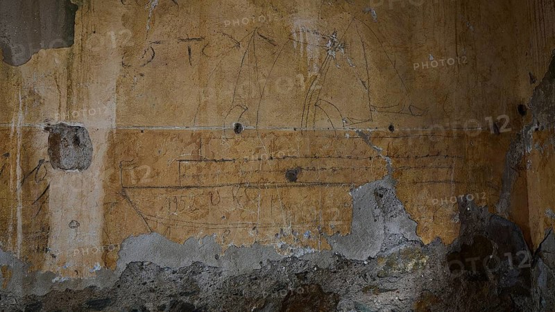 Artful drawing of a sailing ship on an old, peeling stone wall, Lost Place, Tourtouras Mountain, WW2, World War II, German coastal battery PL 388, marine artillerymen, Diapori, Xirokambos, Leros, Dodecanese, Greek Islands, Greece