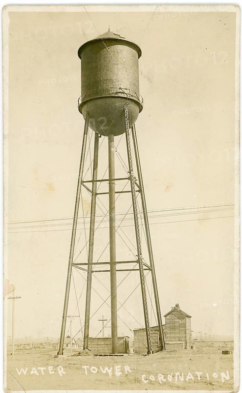 Coronation town, Alberta, Canada, old water tower, inactive, 19th century, A tall metallic water tower in the landscape showing a functional industrial construction, around 1920
