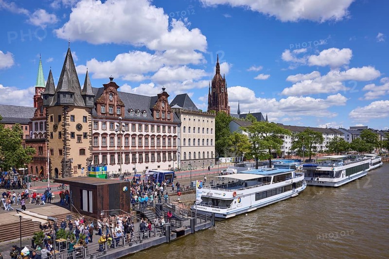Saalhof with rent tower and excursion boats at the Mainkai under a blue sky with cumulus clouds in Frankfurt am Main, Hesse, Germany
