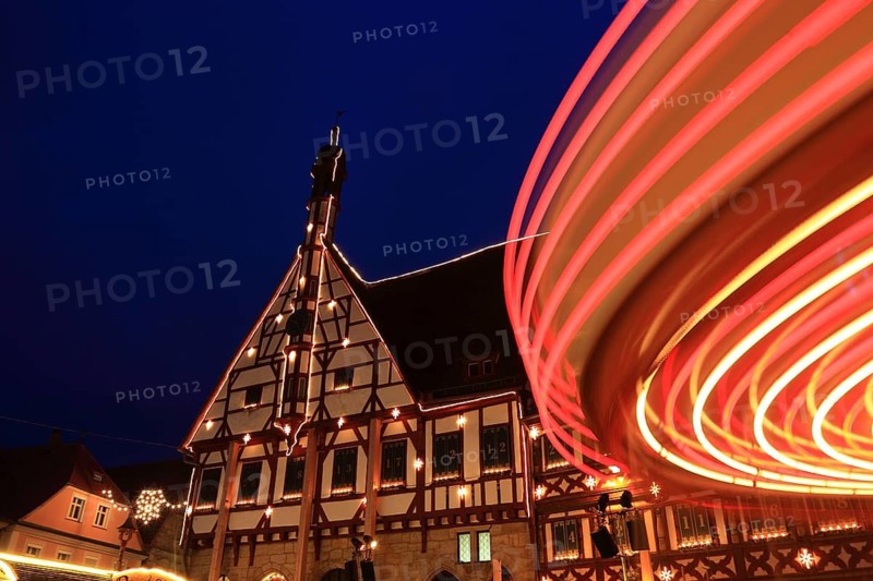 Advent calendar at the town hall, rotating carousel in the foreground, Christmas market in Forchheim, Upper Franconia, Bavaria, Germany