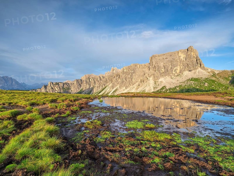 Mountains at sunset, reflection, Dolomites, Passo Giau, Belluno, Italy