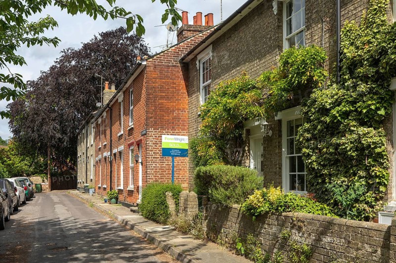 Historic terraced row of houses, St Jiohn's Terrace, Woodbridge, Suffolk, England, UK - sold estate agent sign