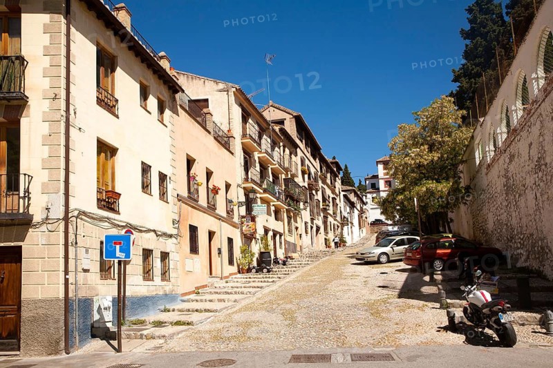 Cuesta de la Victoria street leading uphill into the Albaicin district, Granada, Spain