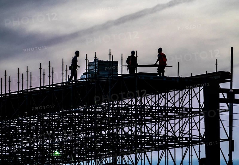 Workers dismantle scaffolding on the Erasmus Bridge over the Nieuwe Maas in Rotterdam, Netherlands