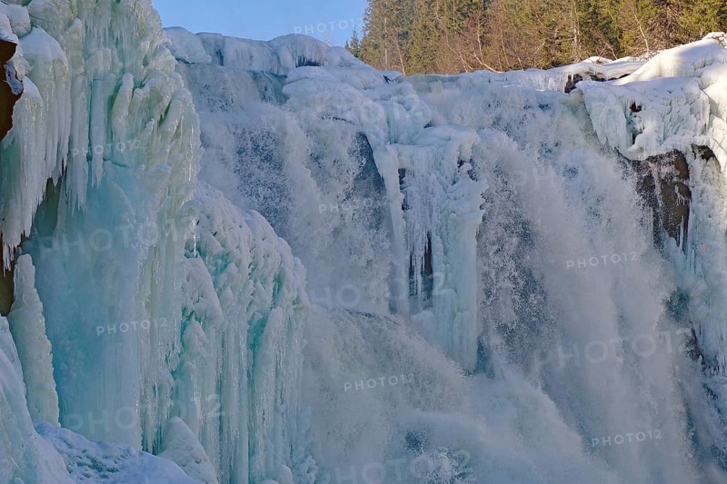 Frozen waterfall surrounded by snow-covered trees and ice formations, winter, Sweden's highest waterfall, Tännforsen, Åreälven, Are, Jämtland, Sweden