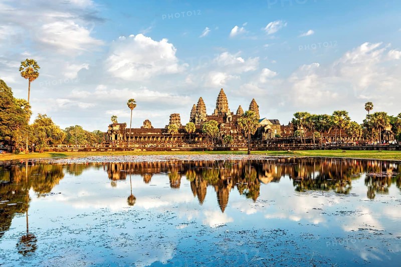 Cambodian landmark Angkor Wat with reflection in water on sunset. Siem Reap, Cambodia