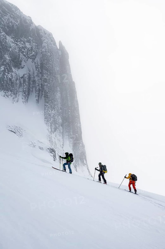 Dramatic atmosphere, Ski tourers, Snowy mountain landscape, Bernese Alps, Bernese Oberland, Switzerland