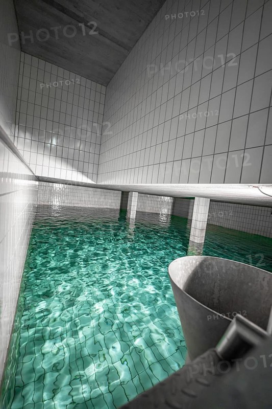 Modern water basin with white tiles and clear water surface, ENCW Netze Calw waterworks, Calw, Black Forest, Germany