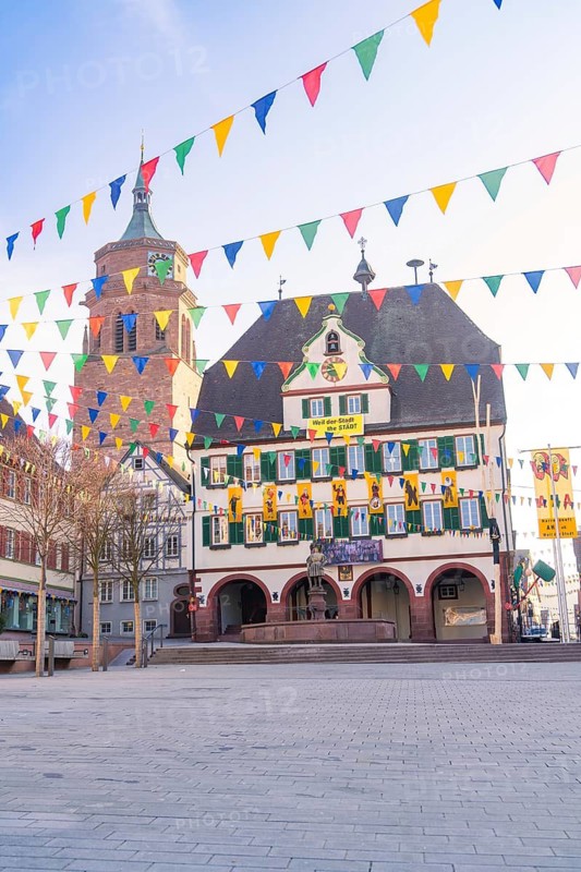 Historic façade with colourful flags in the morning light in a busy town, Fasnet, Weil der Stadt, Böblingen district, Germany