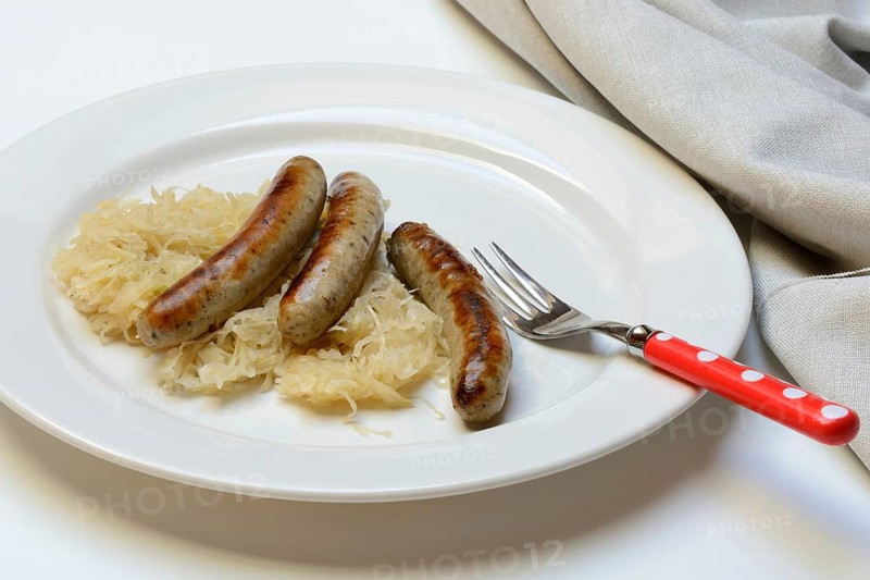 Nuremberg sausages with sauerkraut on a plate, Rostbratwurst, Germany