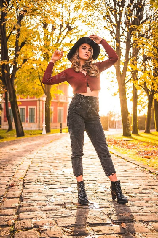 Caucasian girl with hat in a forest walking in autumn